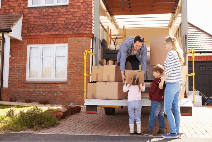 Family unpacking moving truck